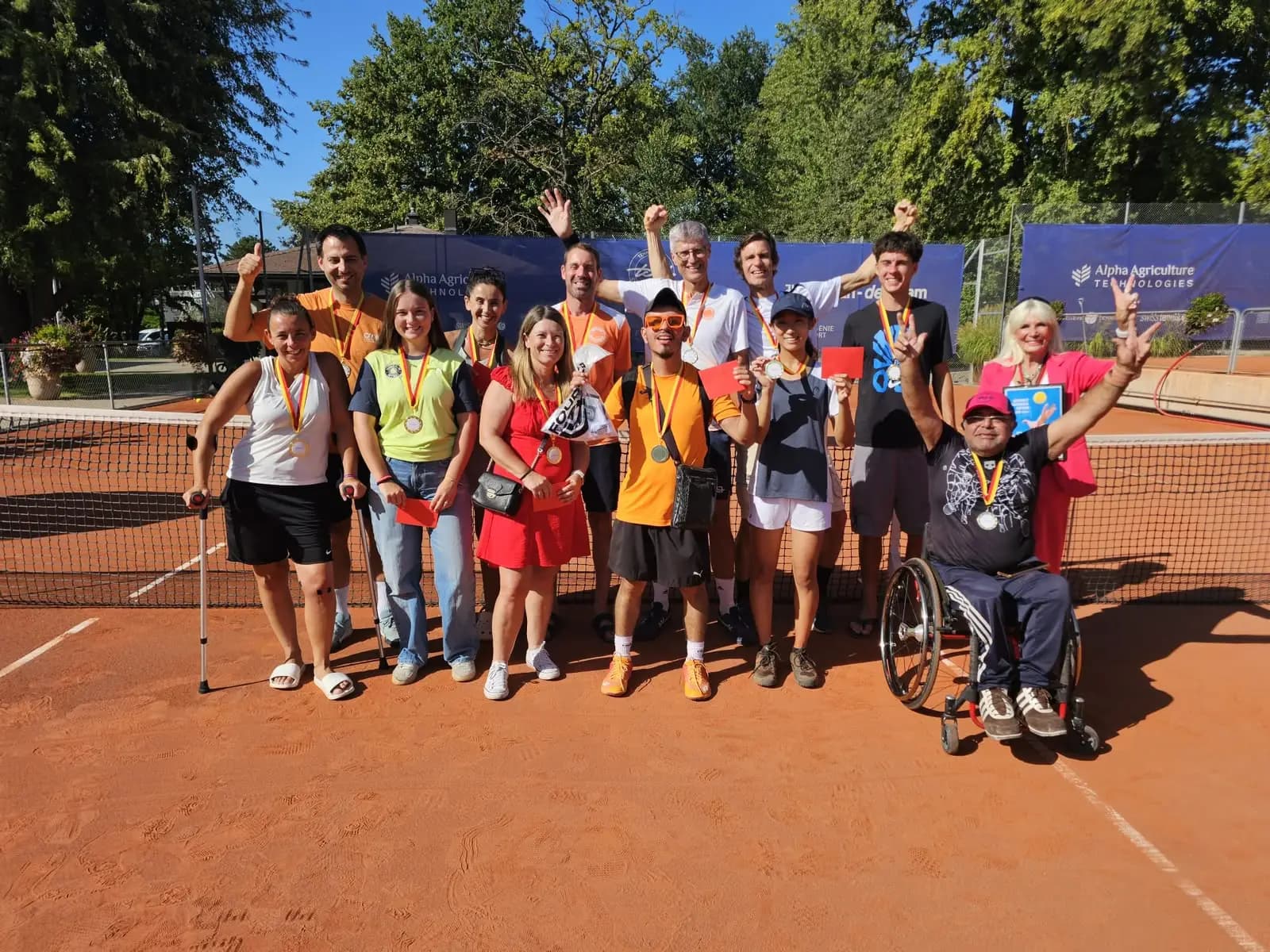 Wheelchair and para tennis champions with their medals on court
