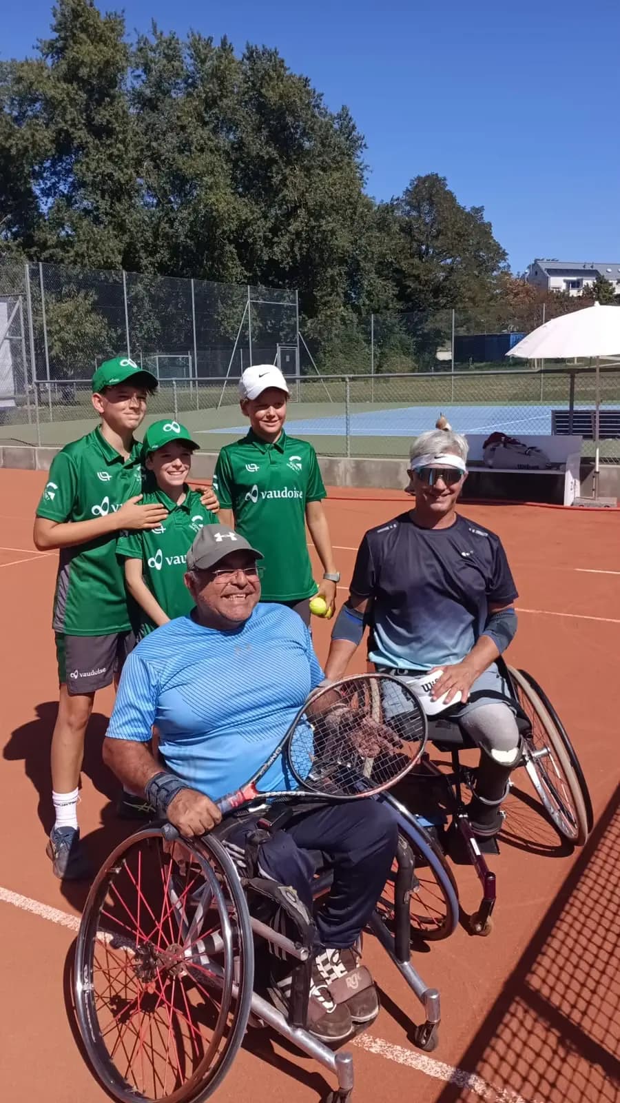 Wheelchair tennis players and young TCCB ball kids